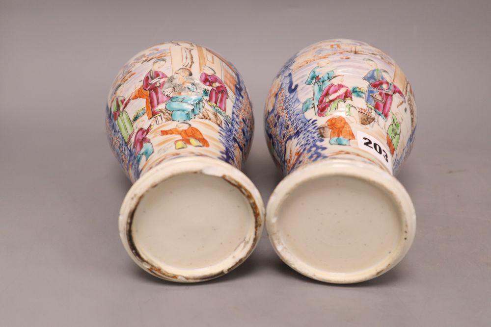 A pair of 18th century Chinese famille rose figural vases, height 25.5cm